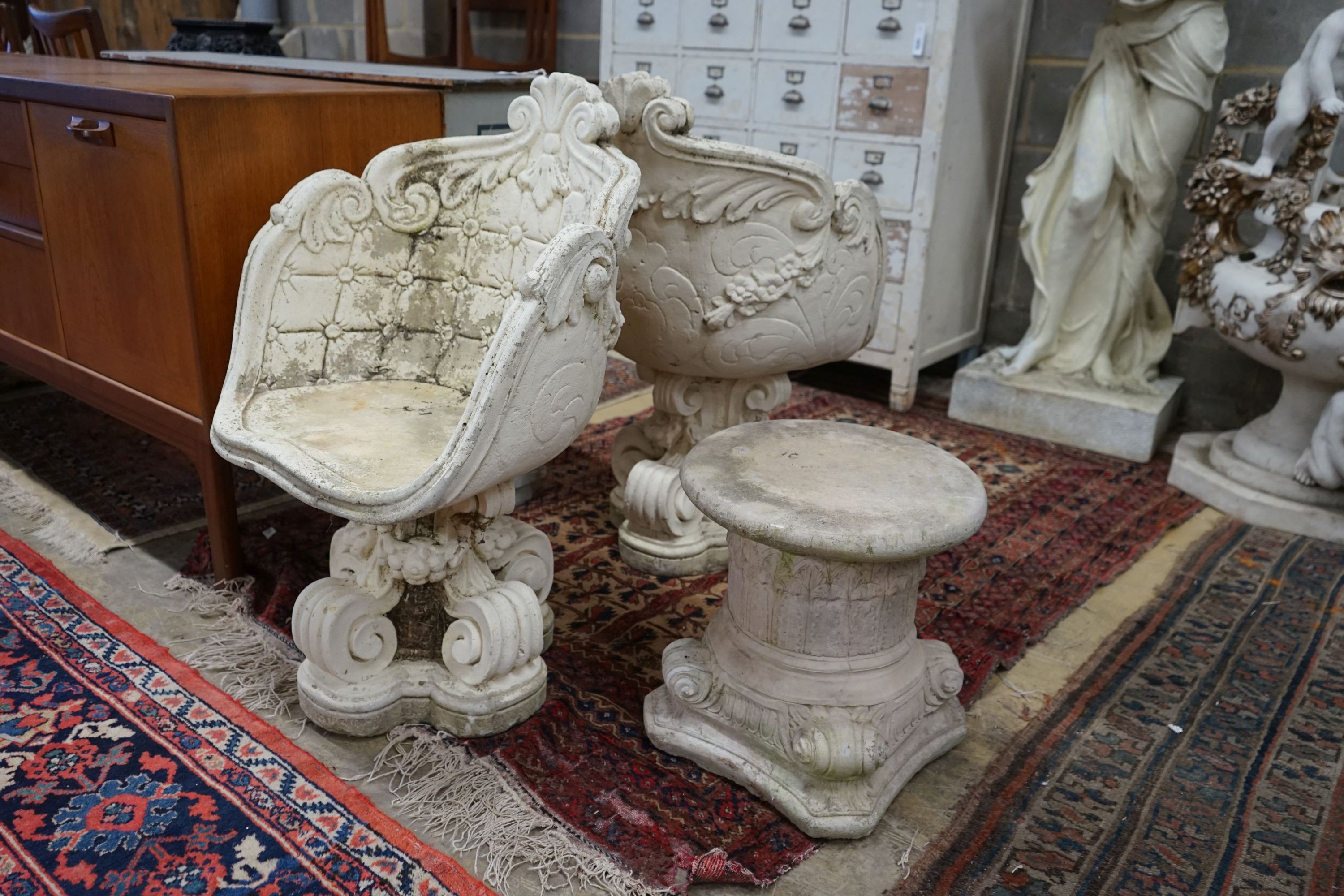 A pair of reconstituted stone tub framed garden chairs, width 55cm, depth 42cm, height 84cm together with a similar low table